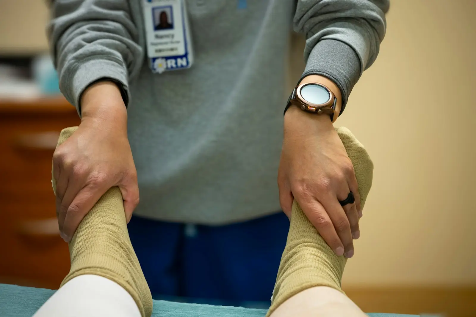 A physiotherapist guiding a patient's leg exercises